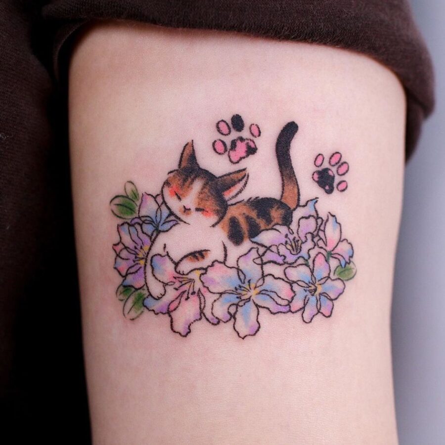 Charming cat resting among colorful flowers Tattoo on skin