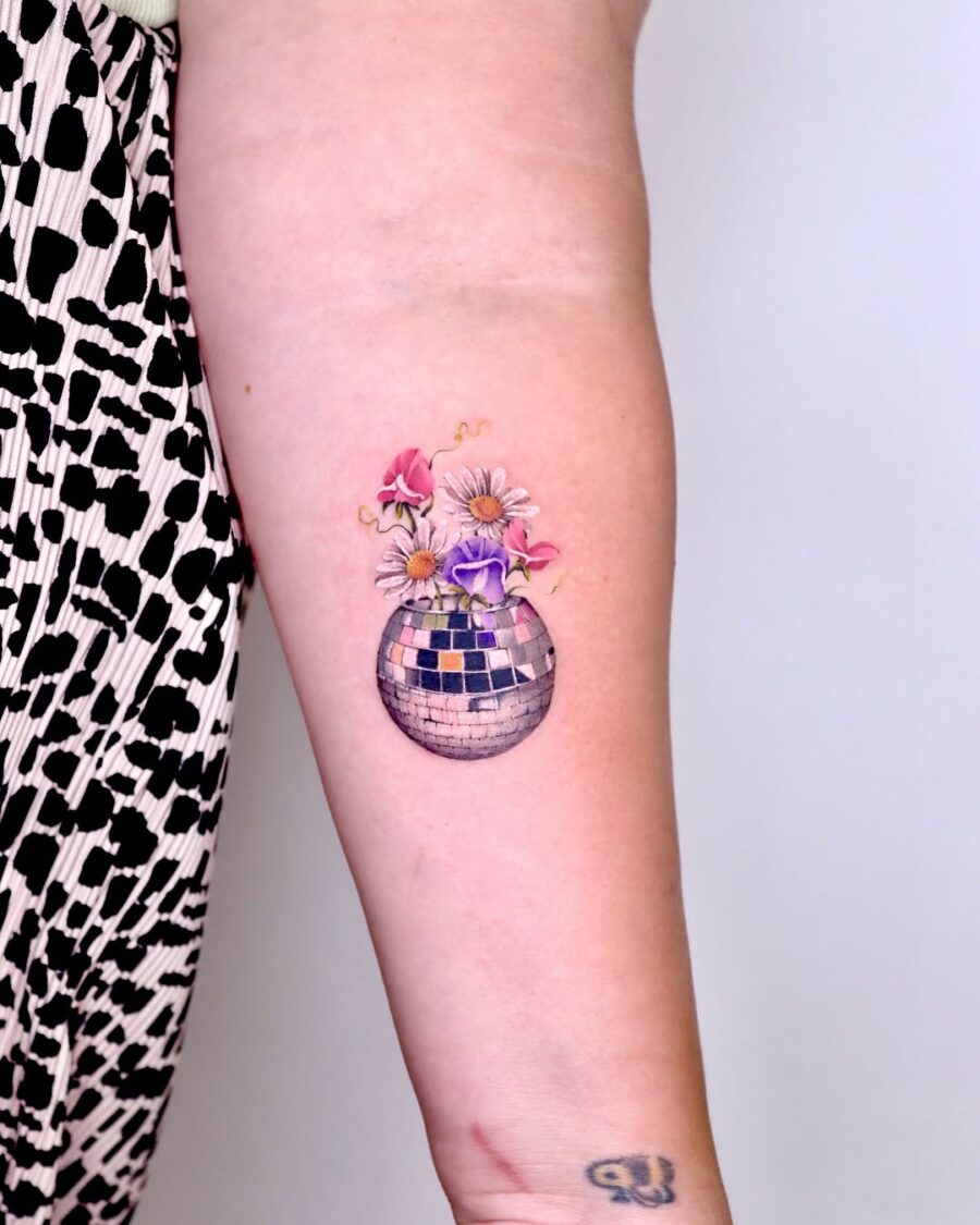 Colorful flowers in disco ball tattoo Tattoo on skin