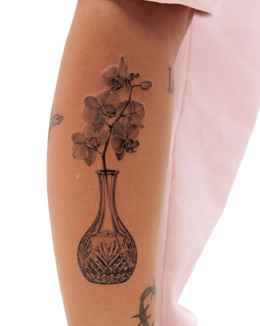 Elegant floral vase tattoo with delicate details Tattoo on skin