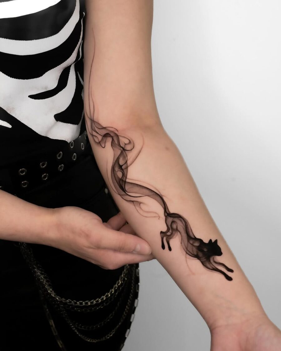 Elegant flow of a minimalist cat tattoo Tattoo on skin