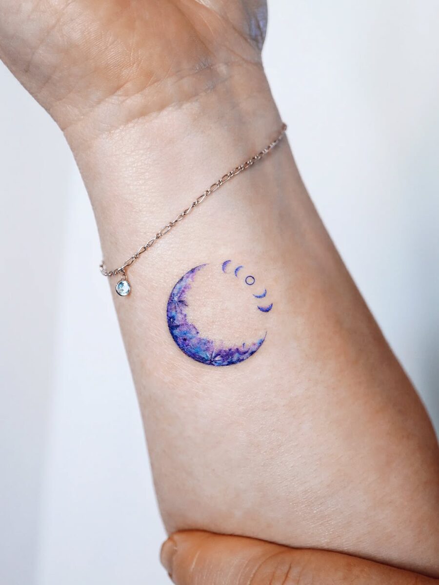 Elegant moon tattoo with cosmic waves Tattoo on skin