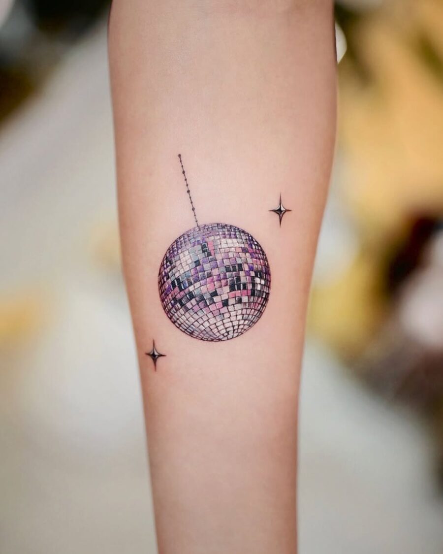 Stylish disco ball tattoo with twinkling stars Tattoo on skin