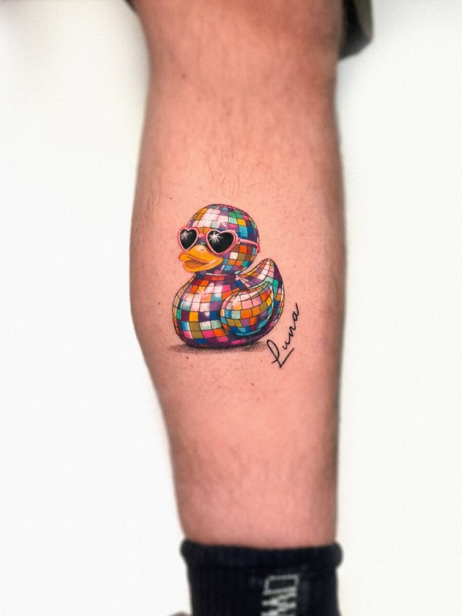 Vibrant disco duck tattoo on the leg Tattoo on skin