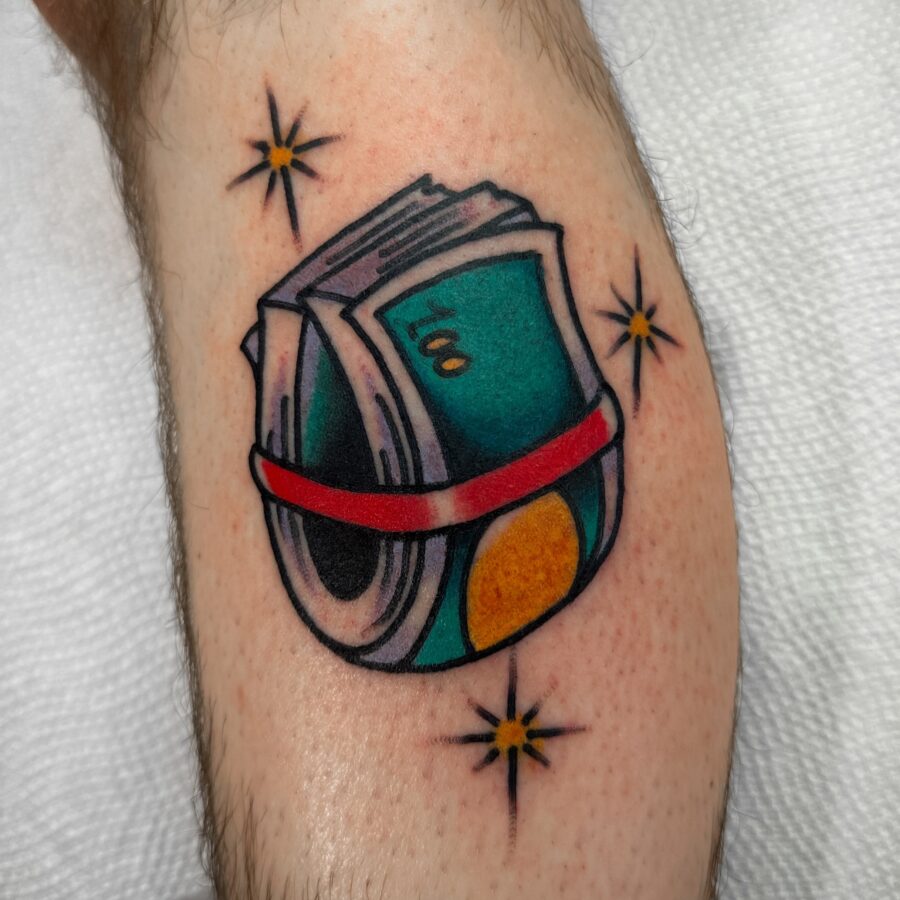 Colorful tattoo featuring bundles of cash Tattoo on skin