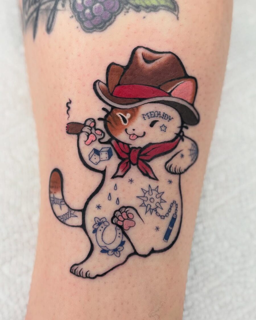 Playful cat showcasing Americana tattoo style Tattoo on skin
