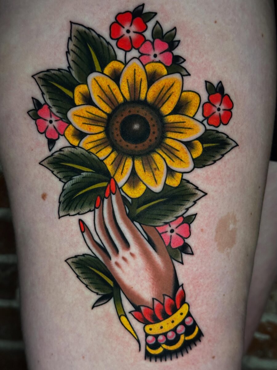 Vibrant Americana Hand with Sunflower and Flowers Tattoo on skin