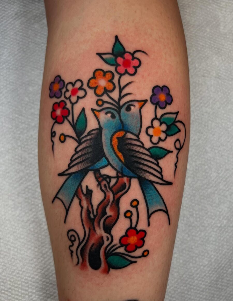 Vibrant Americana Tattoo with Birds and Flowers Tattoo on skin