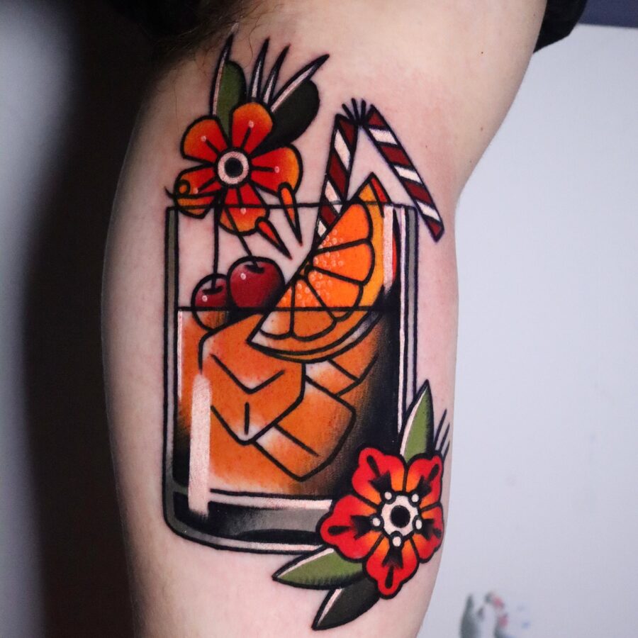 Vibrant cocktail tattoo with floral elements Tattoo on skin