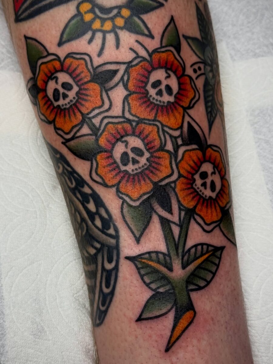Vibrant Floral Skulls in Americana Style Tattoo on skin