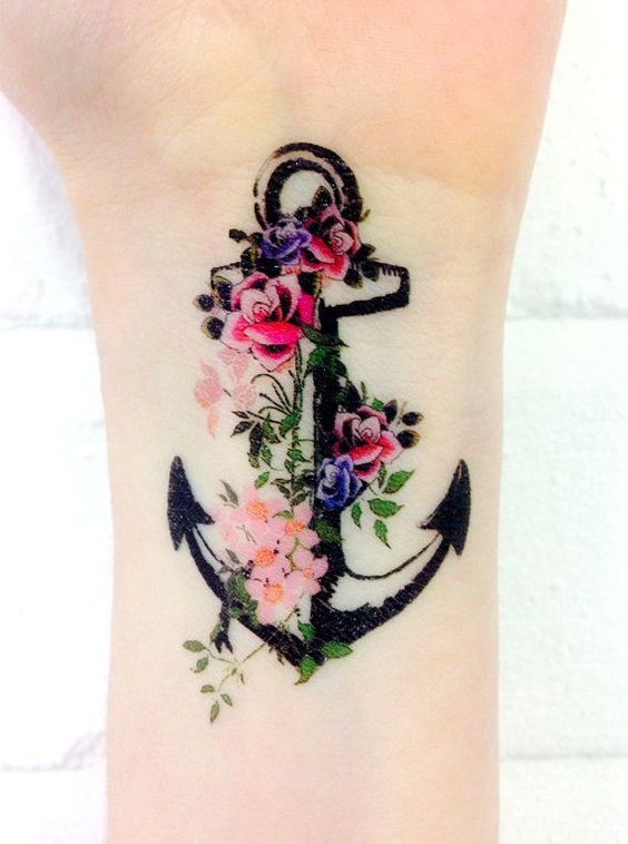Roses On An Old Anchor Body Art Tattoo on skin
