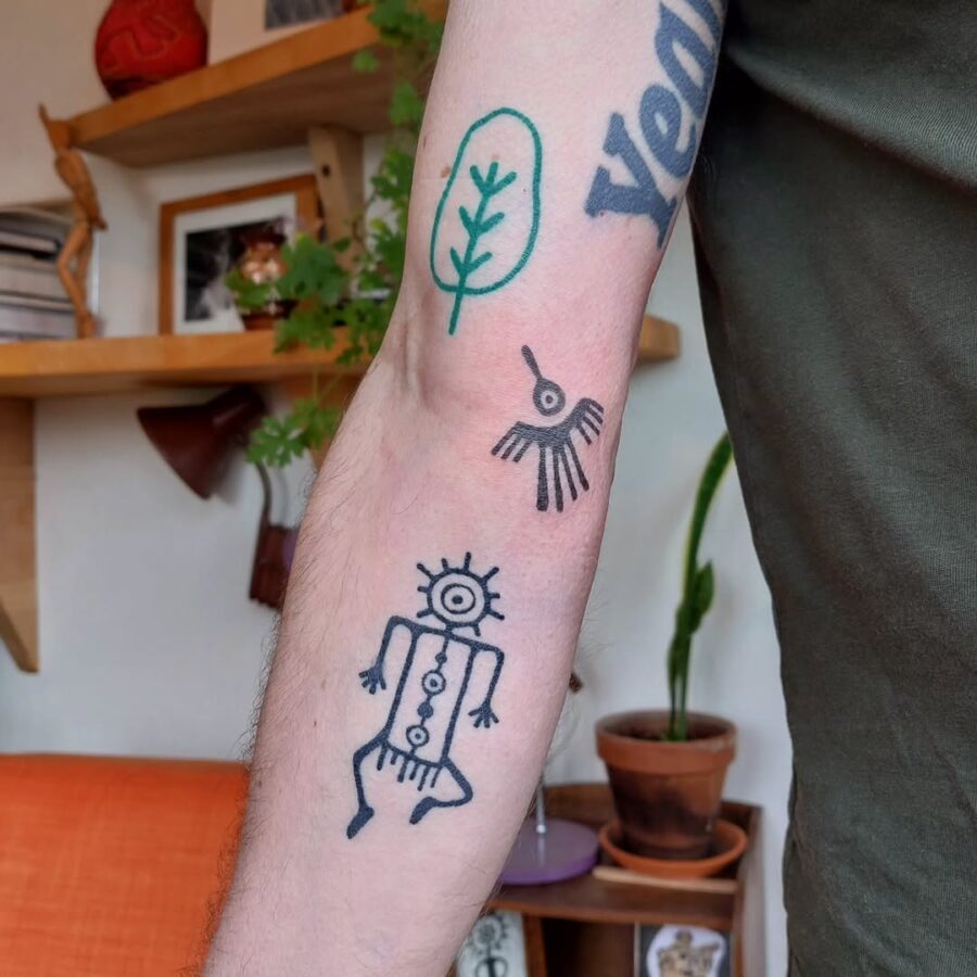 Hand-drawn symbols inspired by ancient art culture Tattoo on skin