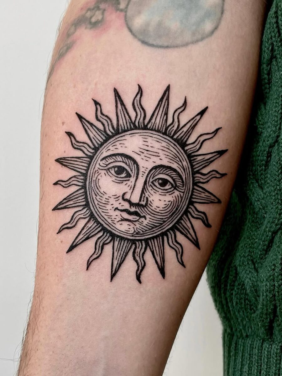 Intricate sun tattoo with classic vintage flair Tattoo on skin