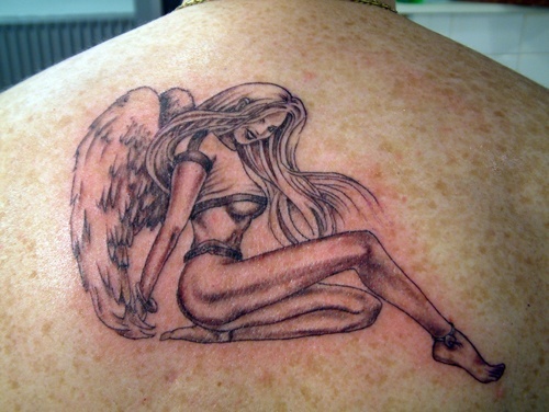 A Vintage Pin-Up Angel Tattoo Design Between Shoulder Blades Tattoo on skin