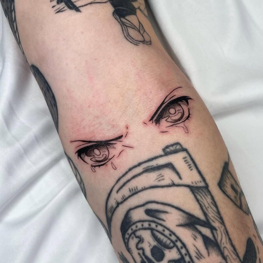 Expressive anime eyes with a tearful vibe Tattoo on skin