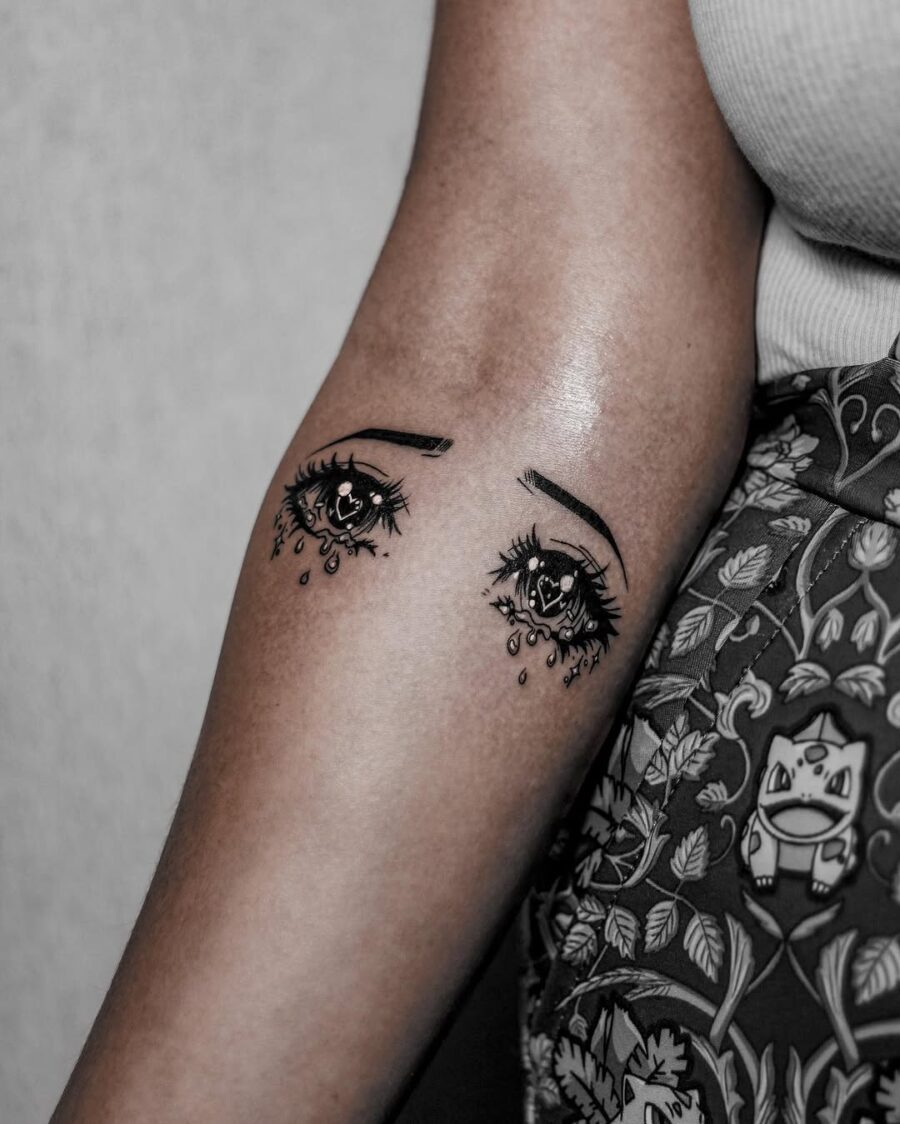Expressive anime eyes with teardrops Tattoo on skin