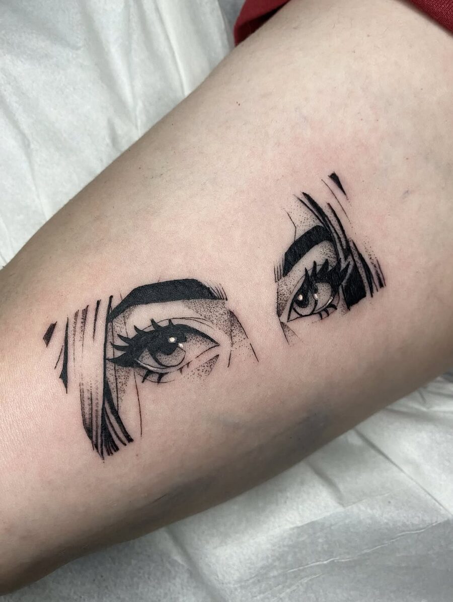 Striking Anime Eyes Tattoo in Black Ink Tattoo on skin