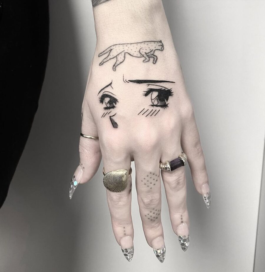 Unique anime eyes tattoo on hand Tattoo on skin