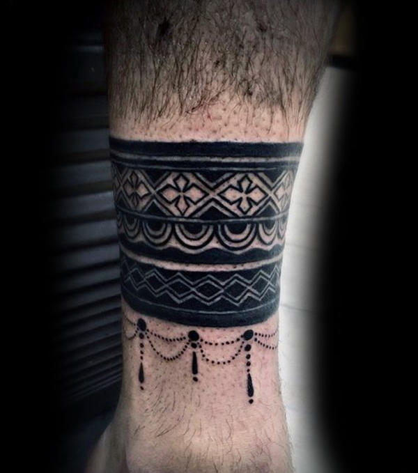 Bands of Several Patterns and Draping Beads that represent hope Tattoo on skin