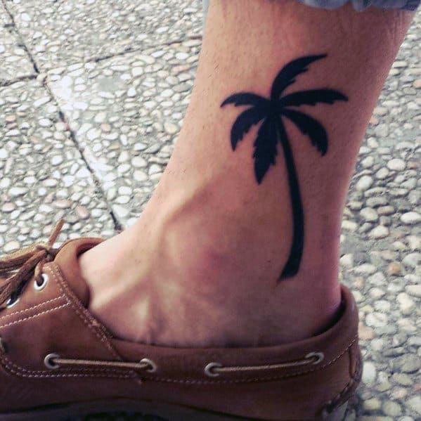 Black Palm Tree Growing From Ankle for Various Skin Tones Tattoo on skin