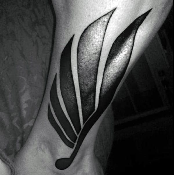 Stylized Wing In Deep Blacks ankle tattoos for Various Skin Tones Tattoo on skin