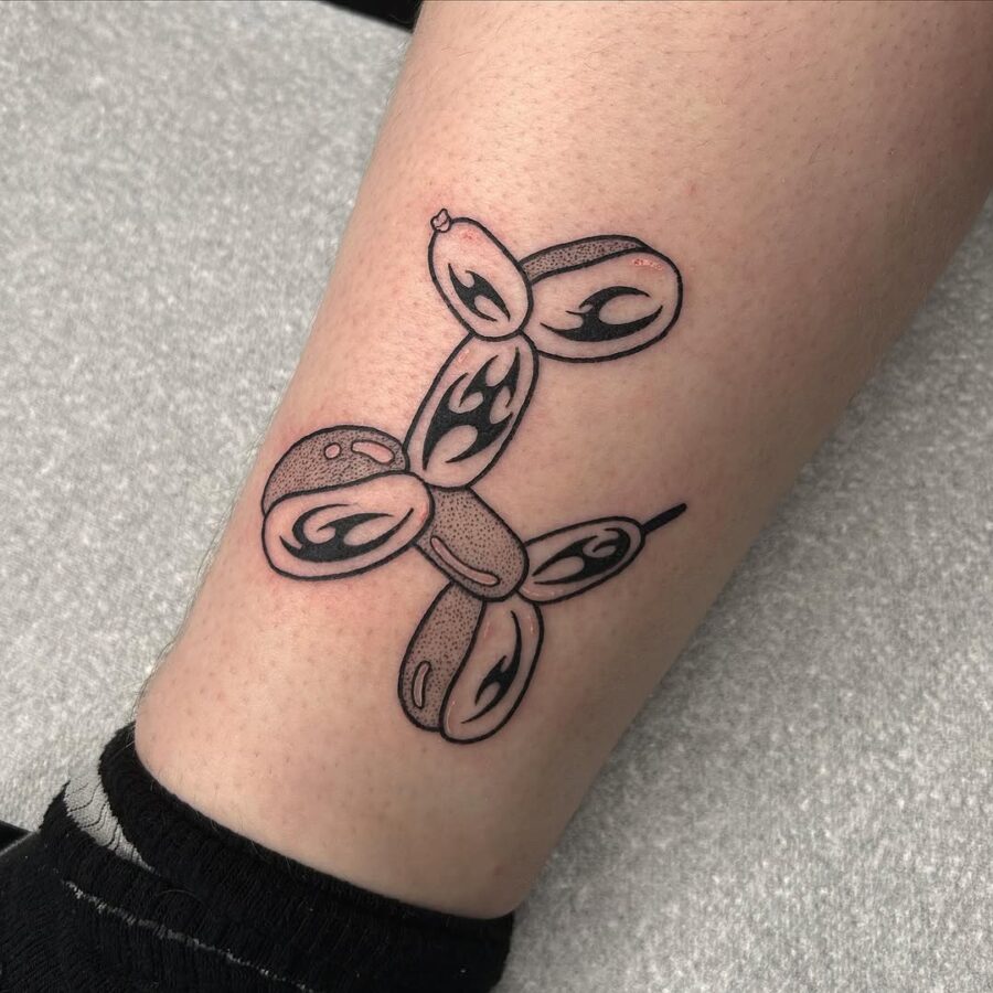 Charming balloon dog tattoo in black ink Tattoo on skin