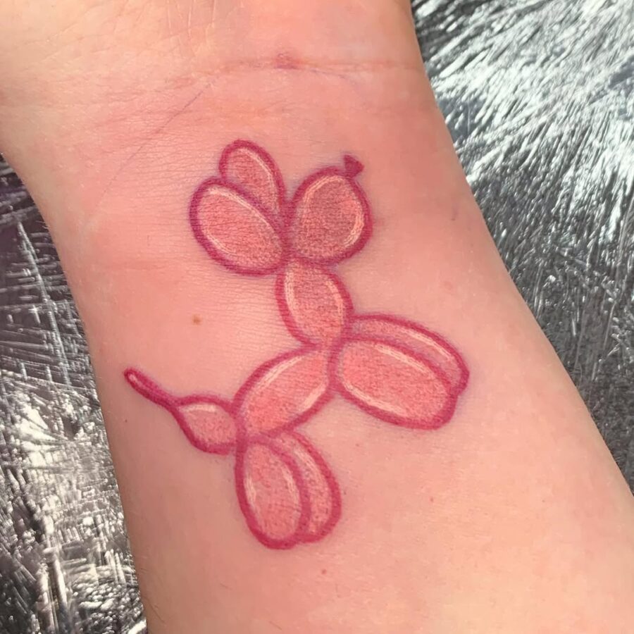 Charming balloon dog tattoo with vibrant colors Tattoo on skin