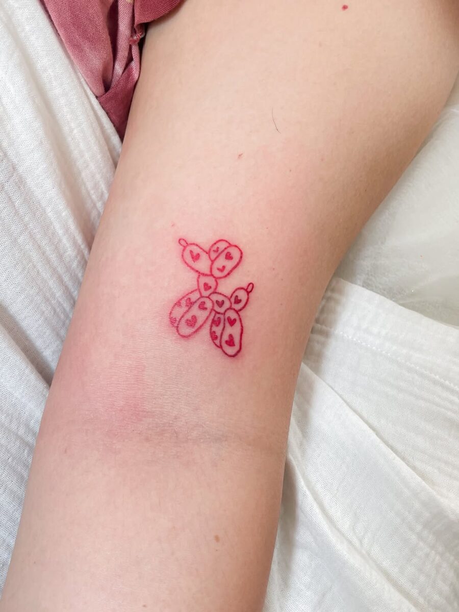 Charming pink balloon dog tattoo design Tattoo on skin