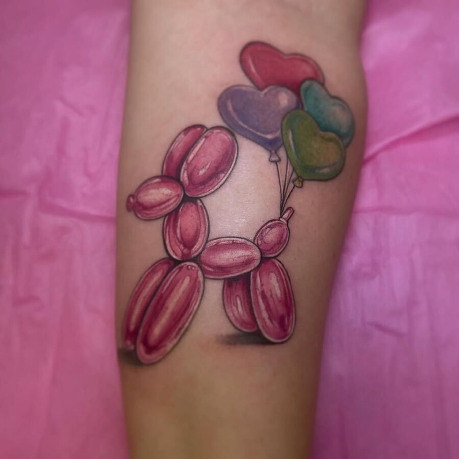Playful balloon dog tattoo with vibrant balloons Tattoo on skin