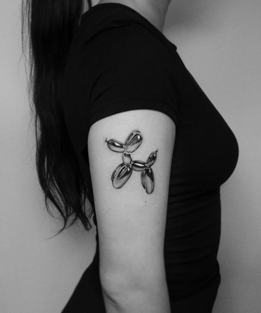 Sleek black and gray balloon dog tattoo design Tattoo on skin