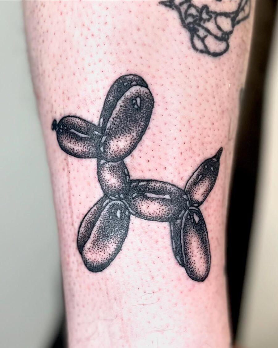 Stylish balloon dog tattoo in black and grey Tattoo on skin