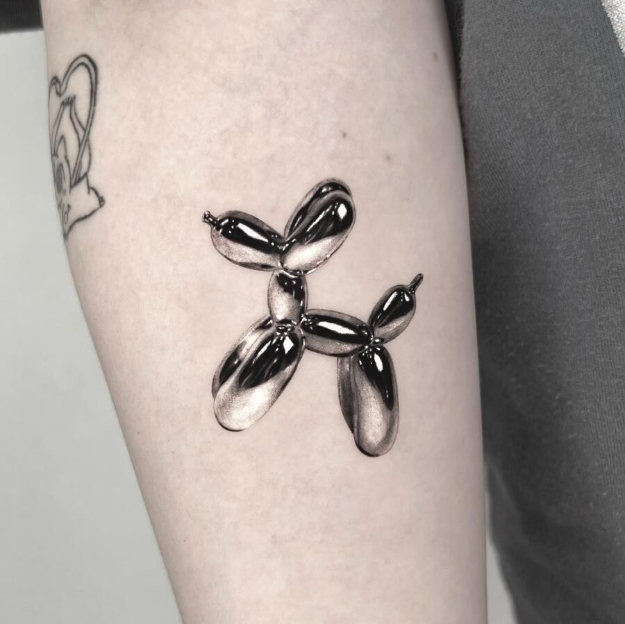 Stylish Balloon Dog Tattoo in Black Ink Tattoo on skin