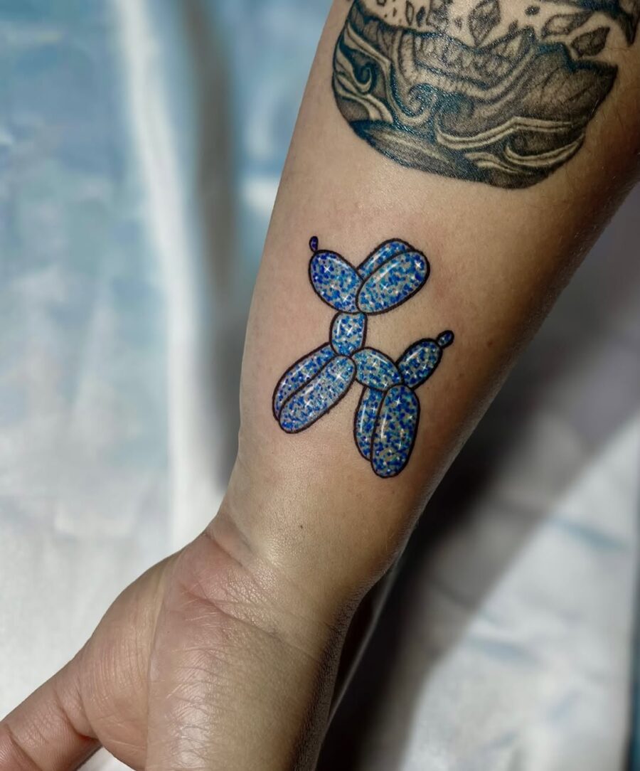 Vibrant balloon dog tattoo with glittery allure Tattoo on skin