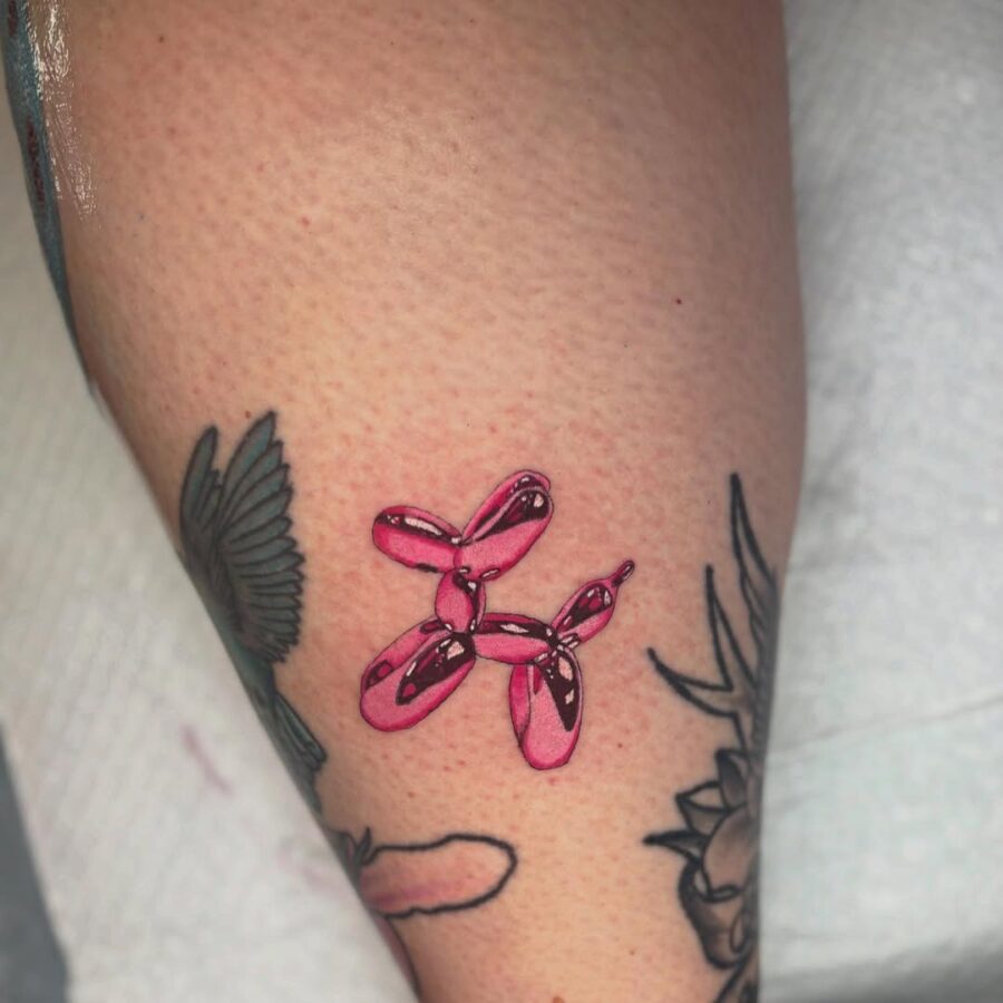 Vibrant pink balloon dog tattoo design Tattoo on skin