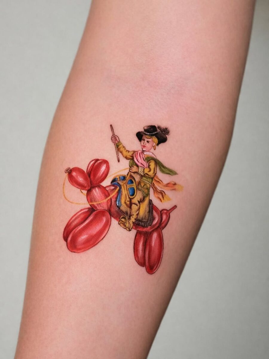 Whimsical balloon dog tattoo featuring a playful boy Tattoo on skin
