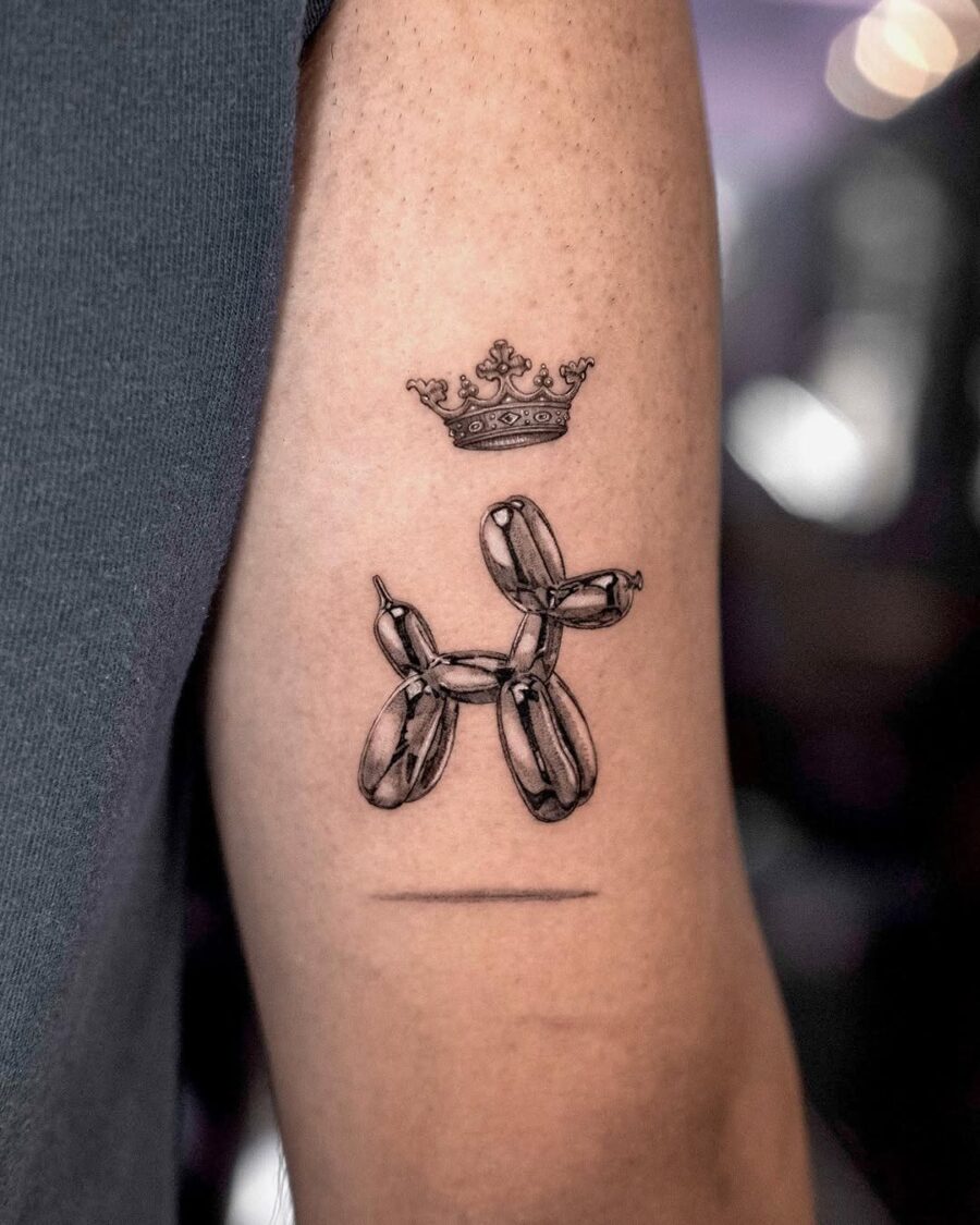Whimsical balloon dog tattoo with royal crown Tattoo on skin