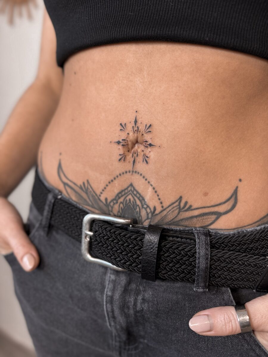 Captivating belly tattoo with floral elements Tattoo on skin