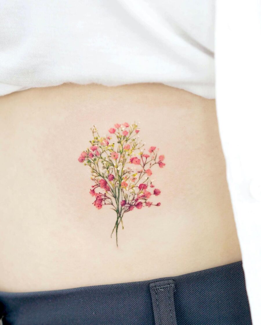Delicate floral belly tattoo with vibrant colors Tattoo on skin