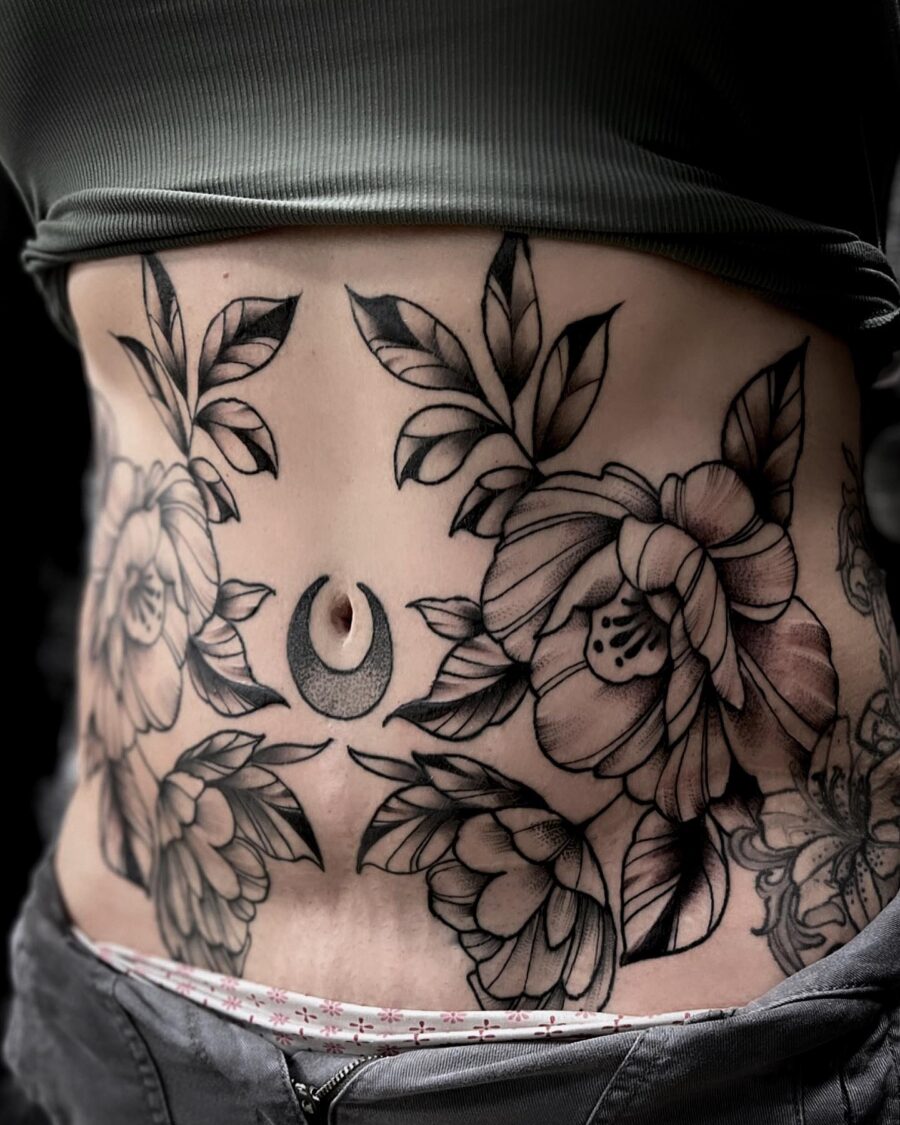 Elegant floral belly tattoo with a crescent moon Tattoo on skin