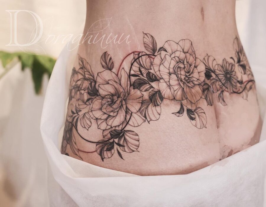Elegant floral belly tattoo with intricate details Tattoo on skin