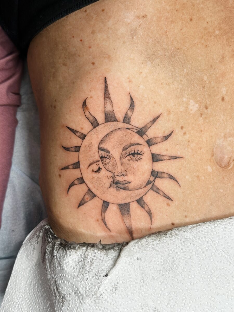 Intricate sun and moon belly tattoo design Tattoo on skin