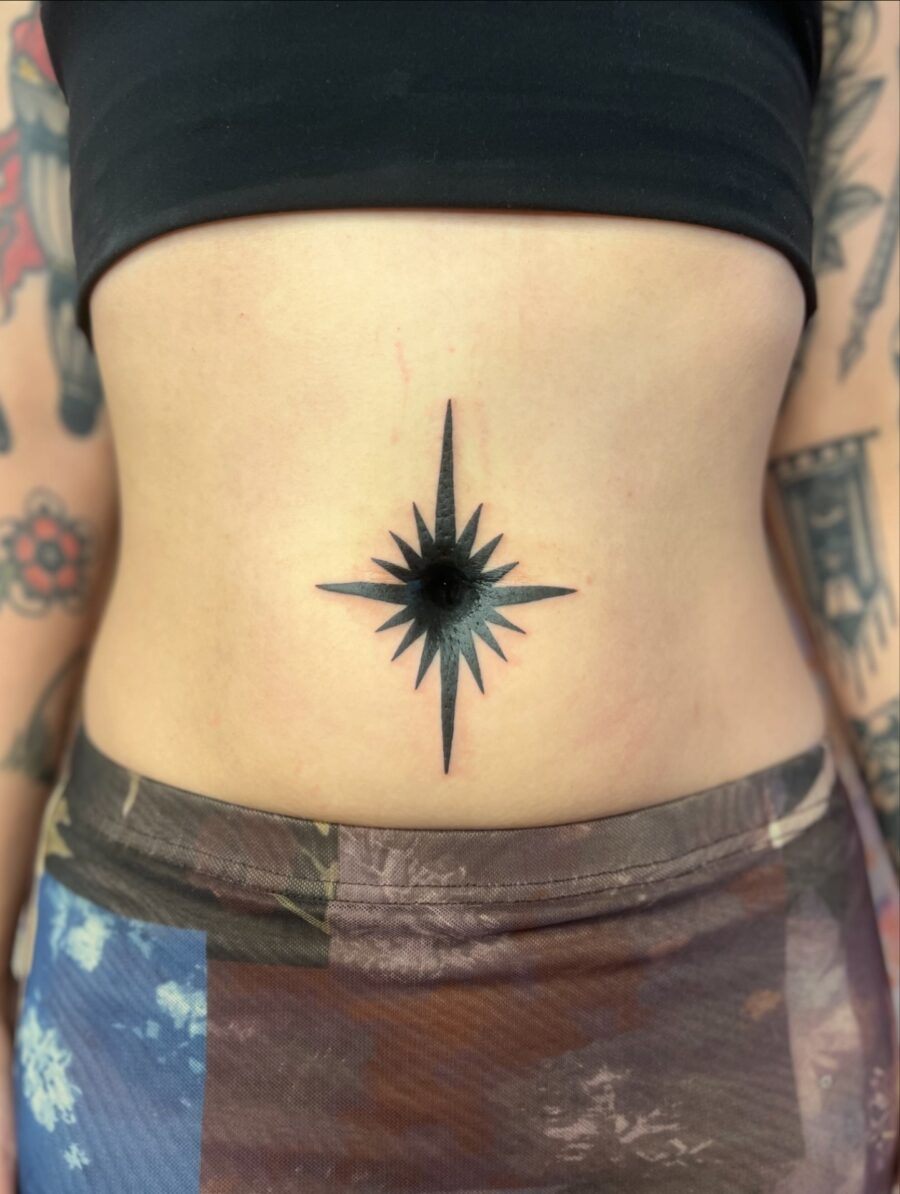 Striking Black Star Compass Belly Tattoo Tattoo on skin
