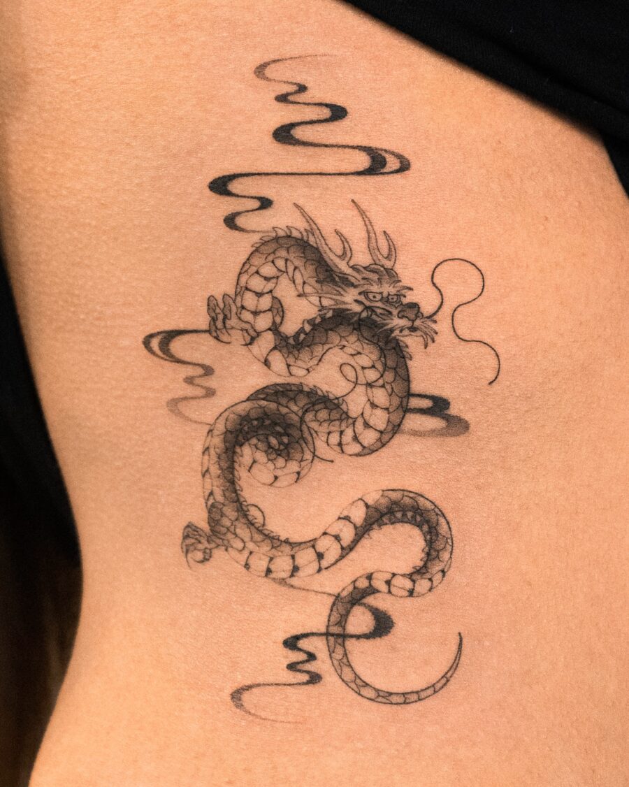 Stunning belly dragon tattoo with swirling clouds Tattoo on skin