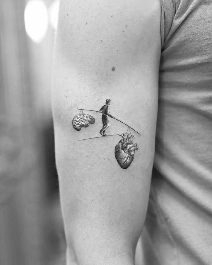 Man Balancing Heart and Mind Bicep Tattoo Ideas Tattoo on skin