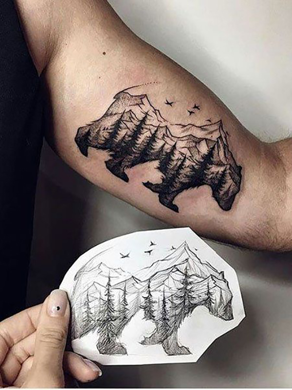 Mountains and Trees Within a Bear Inner Bicep Tattoo Ideas Tattoo on skin