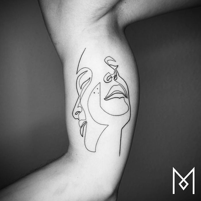 Single Line Creates Merged Faces on this Inner Bicep Tattoo Ideas Tattoo on skin