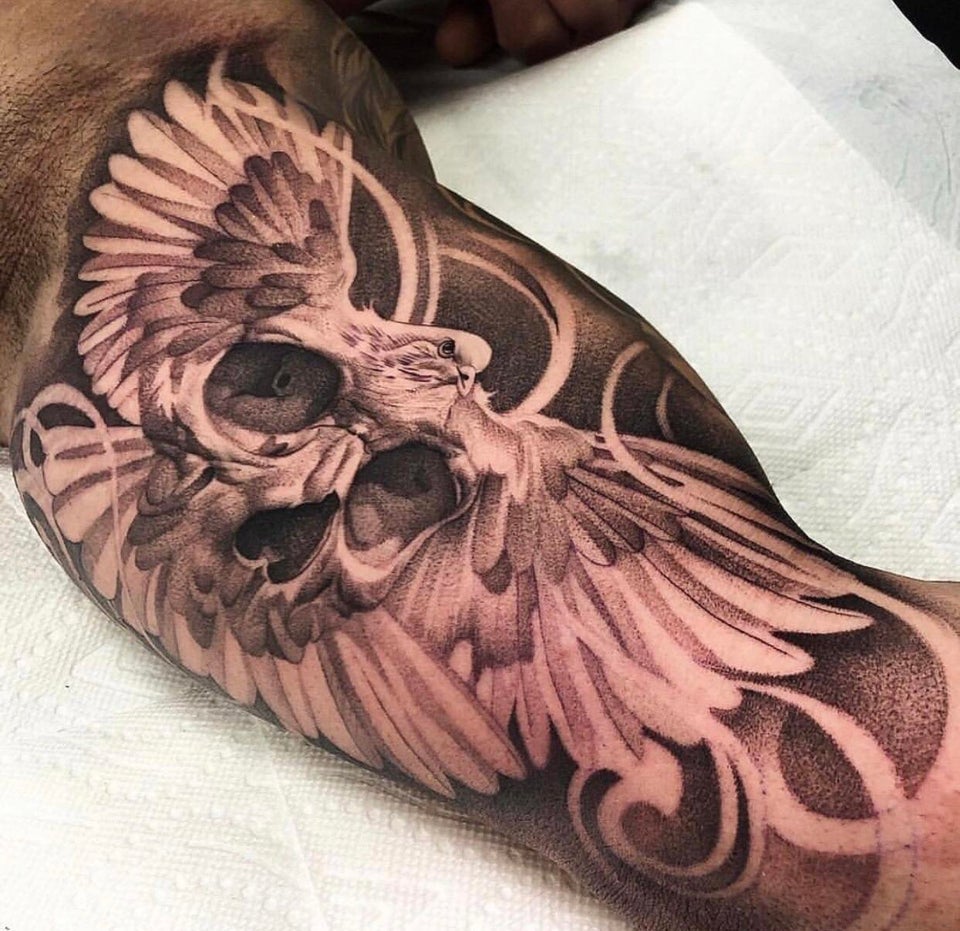 Human Skull Within a Dove Inner Bicep Tattoo Ideas Tattoo on skin