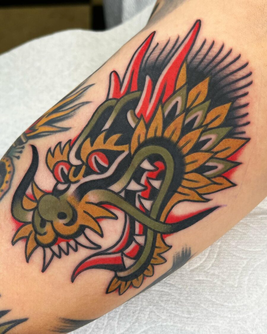 Bold dragon design on bicep tattoo Tattoo on skin