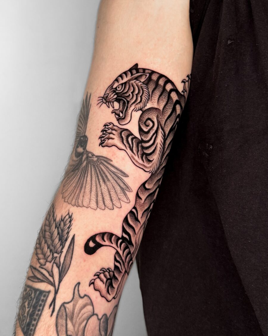Bold tiger tattoo showcasing sleek detailing Tattoo on skin