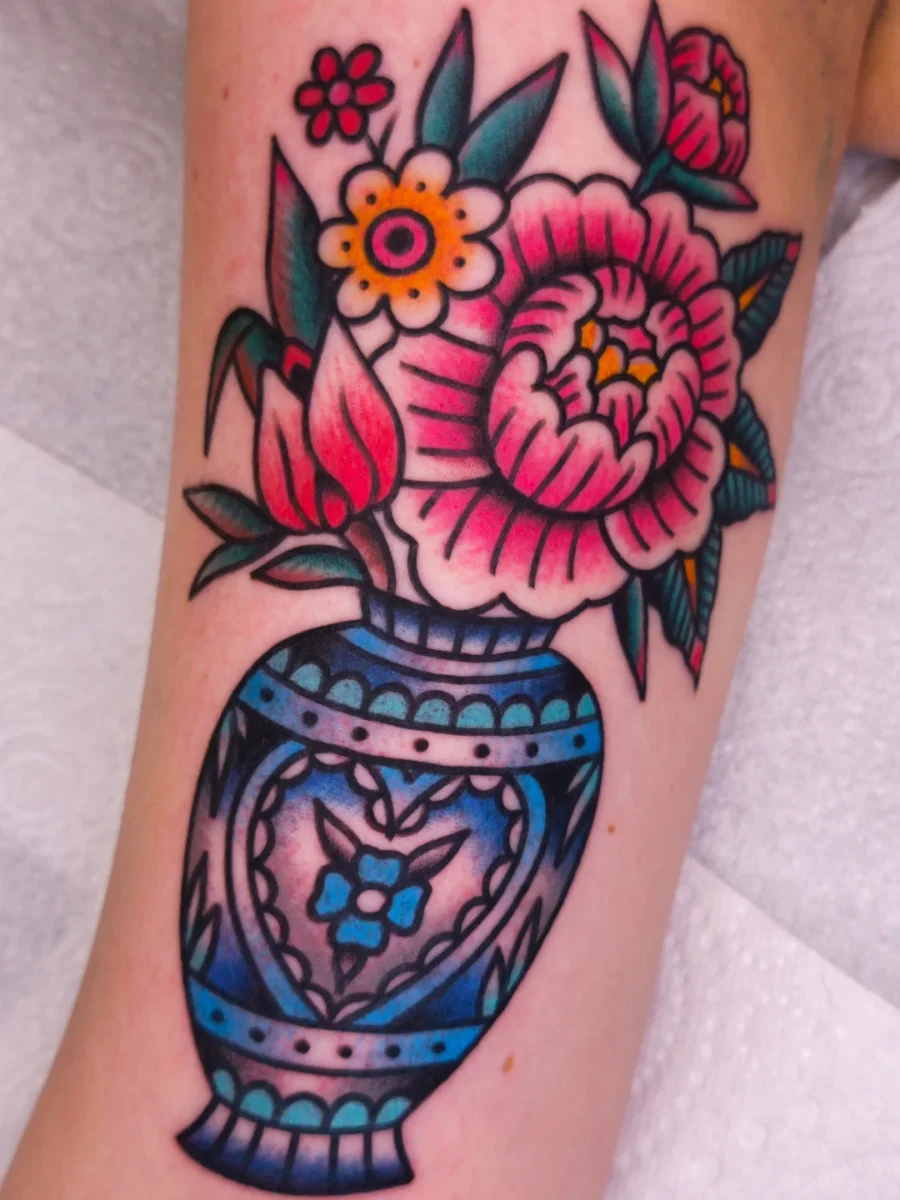 Colorful floral design in a unique vase Tattoo on skin