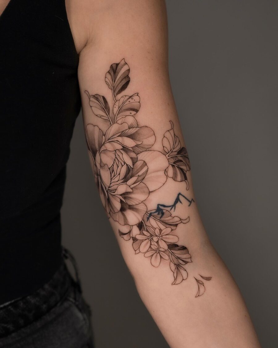 Elegant floral tattoo design on bicep Tattoo on skin